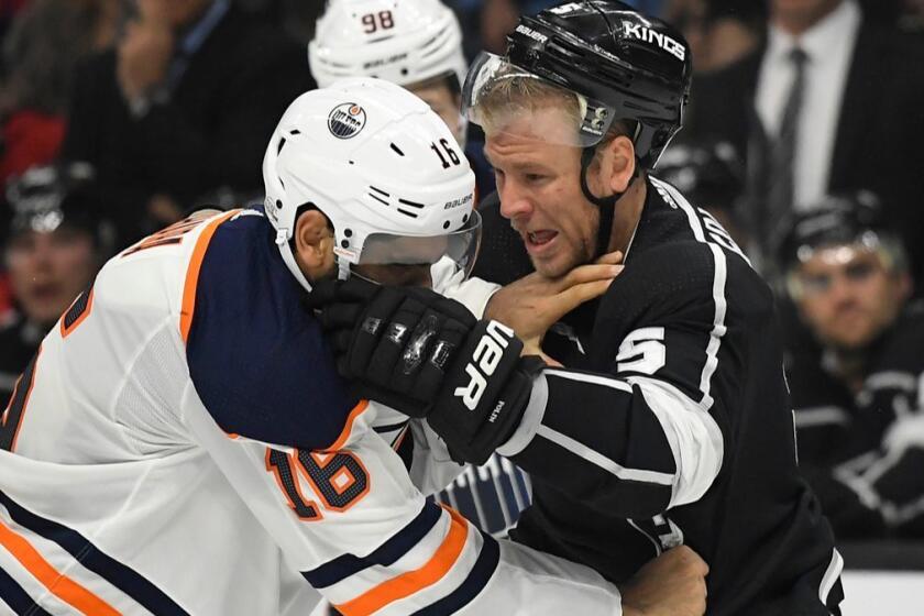 Edmonton Oilers left wing Jujhar Khaira, left, and Los Angeles Kings defenseman Christian Folin, of Sweden, fight during the first period of an NHL hockey game, Wednesday, Feb. 7, 2018, in Los Angeles. (AP Photo/Mark J. Terrill)
