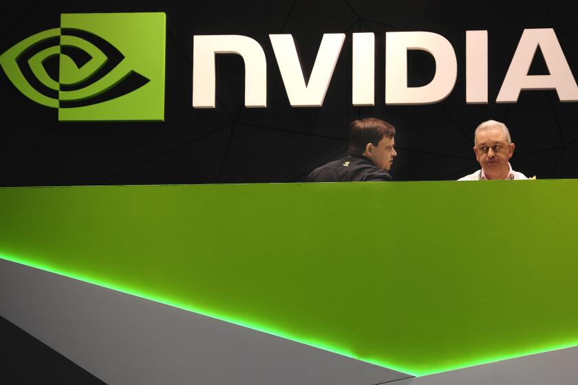 People gather in the Nvidia booth at the Mobile World Congress, the world's largest mobile phone trade show in Barcelona, Spain, Thursday, Feb. 27, 2014. The global wireless show that wraps up on Thursday has seen a push to get mobile devices cheap enough to reach emerging markets without sacrificing so much performance. While the affluent crave the latest iPhones or Android phones, most of the world can't afford the hundreds of dollars they cost. (AP Photo/Manu Fernandez)