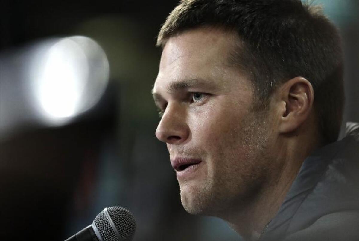 Patriots quarterback Tom Brady answers questions during opening night for Super Bowl LI at Minute Maid Park on Jan. 30.
