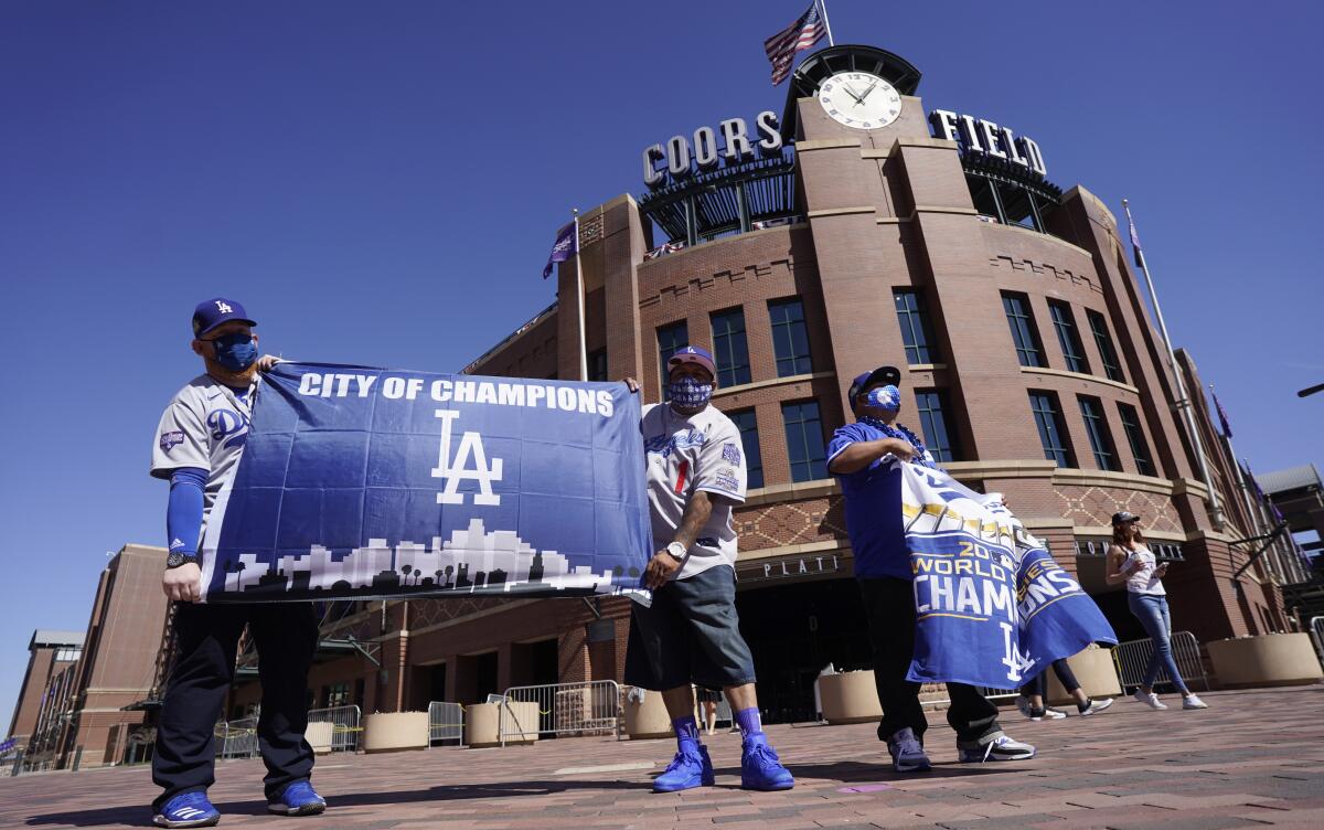 Dodgers fans (from left to right) Oliver Olson, Juan Campo and Rudy Soto stand in front of Coors Field.