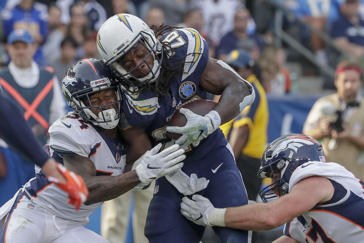 Chargers running back Melvin Gordon III is stopped short of the goal line by Denver Broncos safety Will Parks and linebacker Josie Jewell last November.