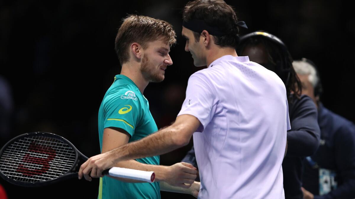 David Goffin, left, receives congratulations from Roger Federer after defeating the Swiss star in the semifinal of the ATP Finals on Saturday.