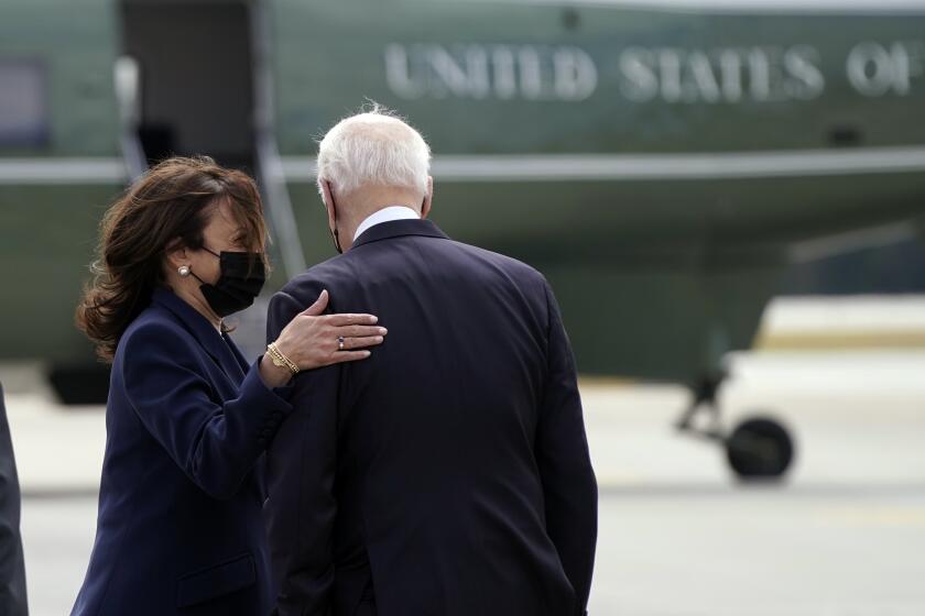 President Joe Biden talks with Vice President Kamala Harris