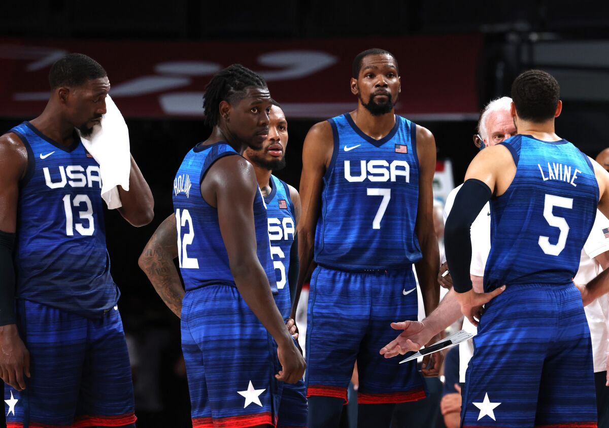 Men in USA jerseys stand on the sideline.
