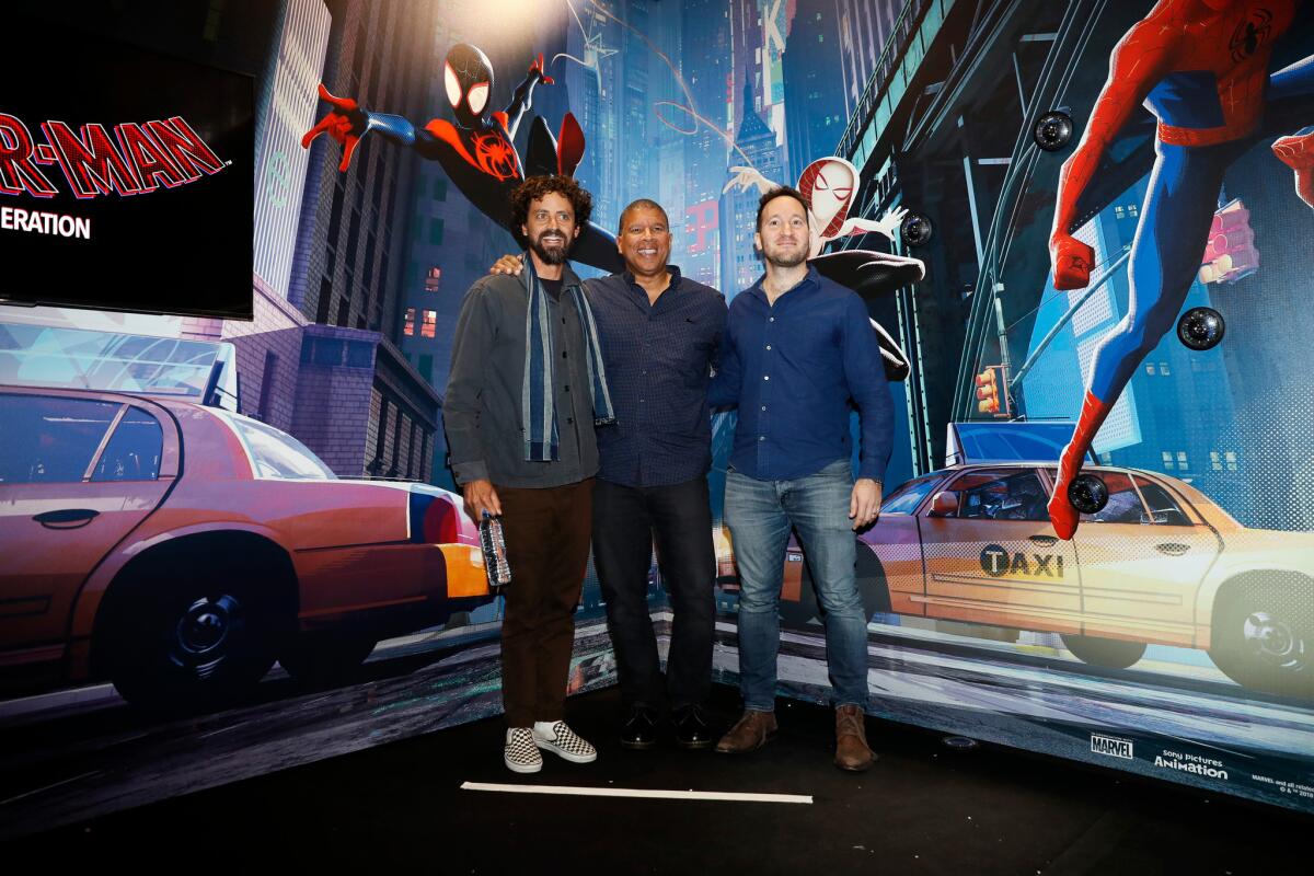 US film co-directors Bob Persichetti, Peter Ramsey and Rodney Rothman pose for the photographers.