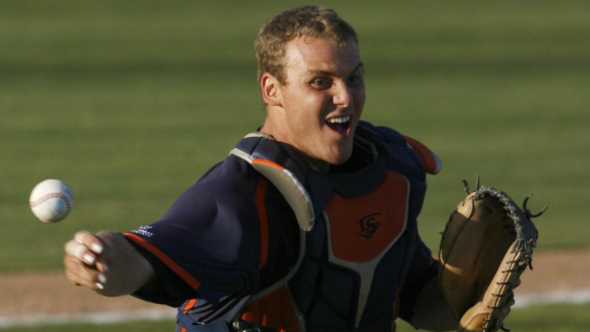 Pepperdine catcher Aaron Barnett throws out a runner at first base during the second inning of the Waves' 10-6 win over Cal Poly in the NCAA regional tournament Sunday.