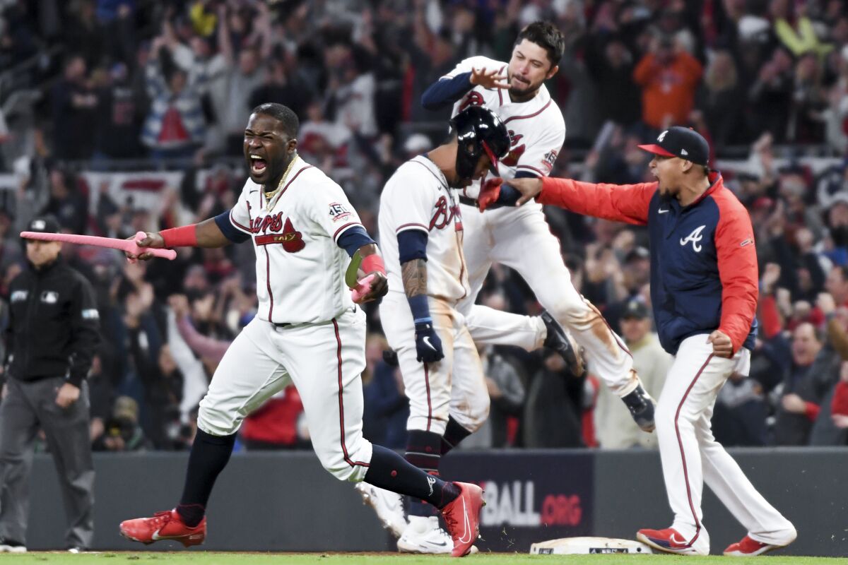The Atlanta Braves celebrate a walk-off single by Eddie Rosario to defeat the Dodgers.