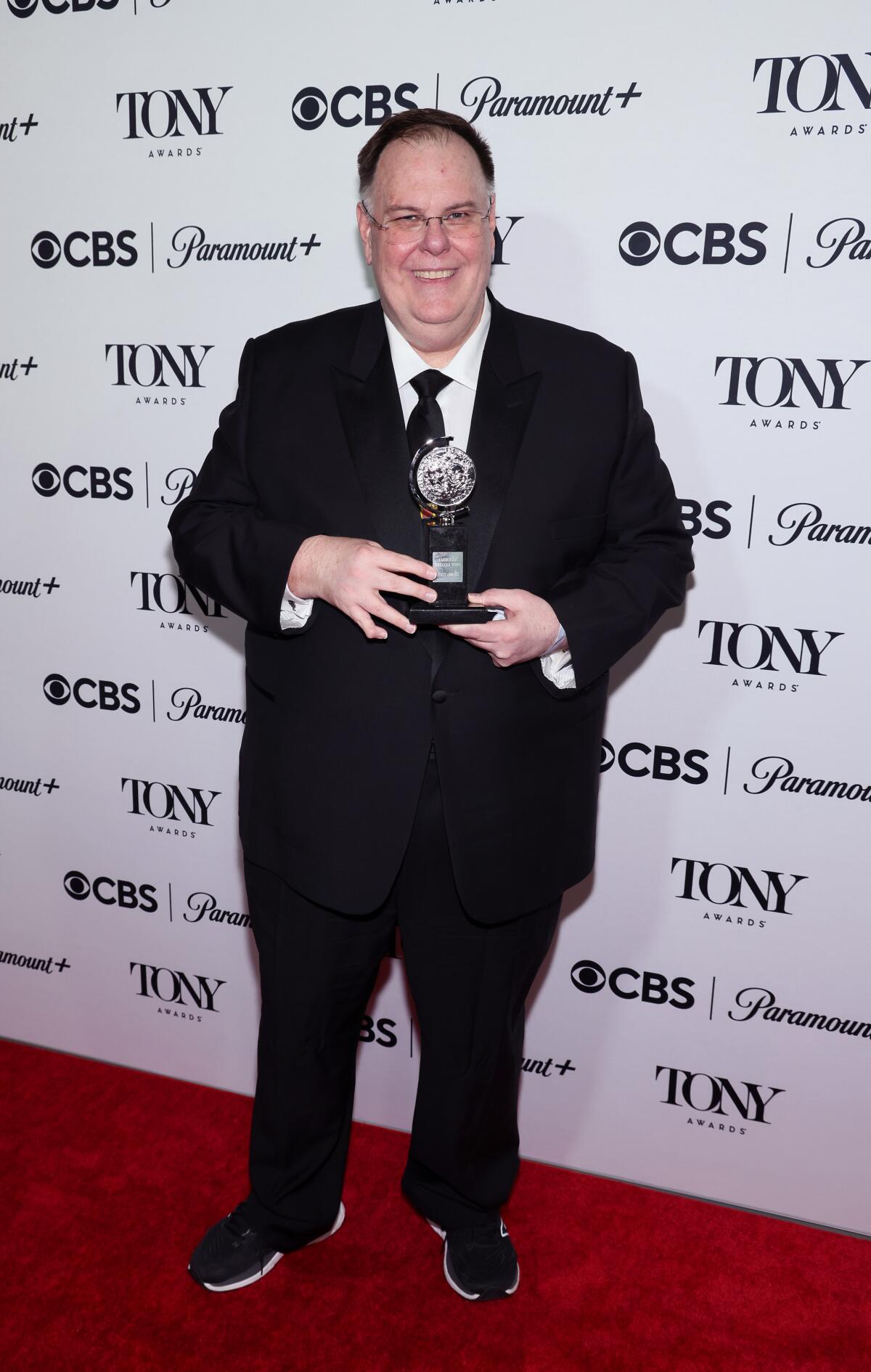 Gregg Barnes holds his 2023 Tony Award.