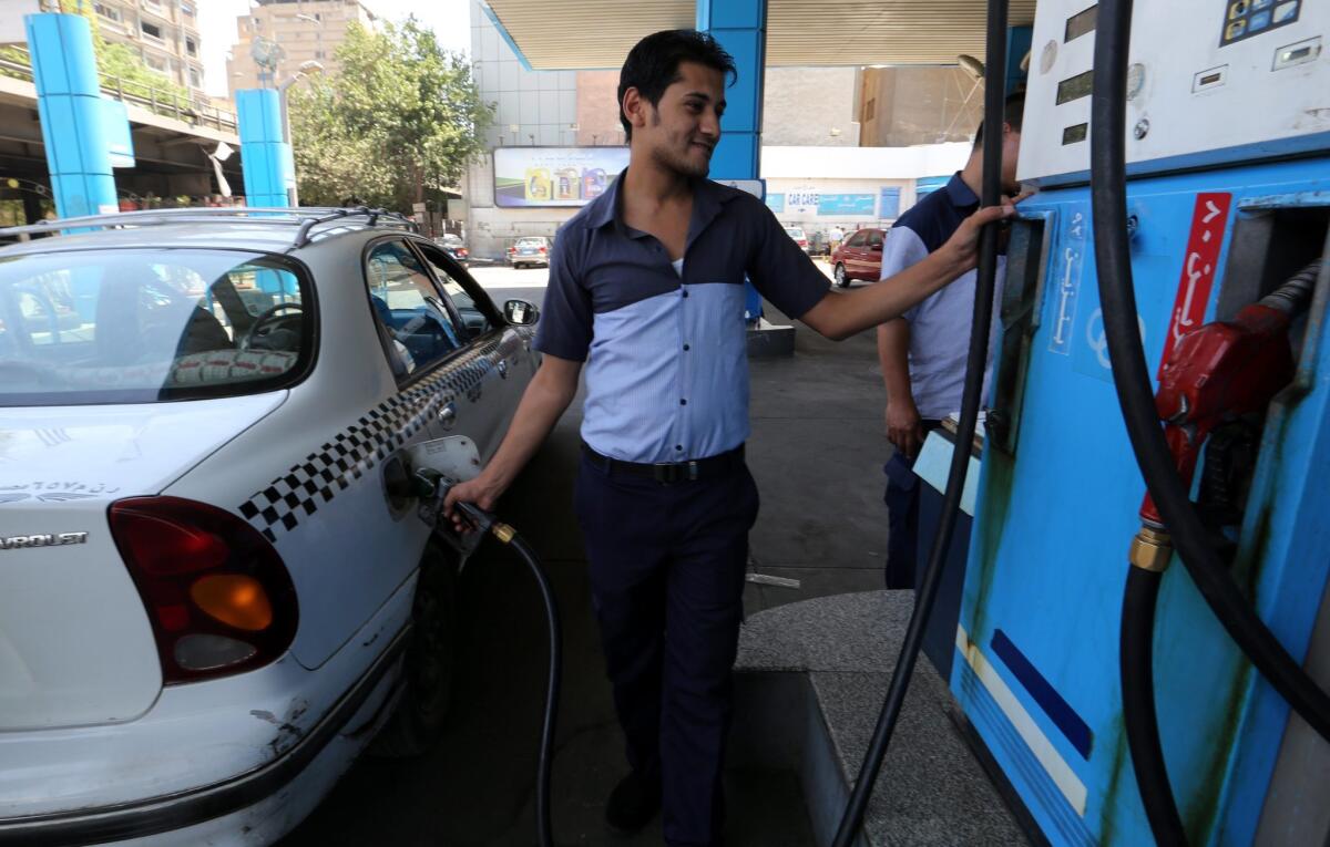An Egyptian worker at a gas station fuels up in Cairo on Saturday.