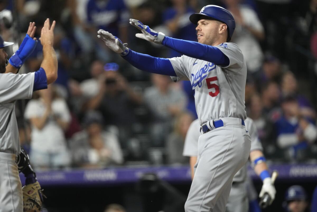 Dodgers' Chris Taylor congratulates Freddie Freeman, who hit a two-run home run.