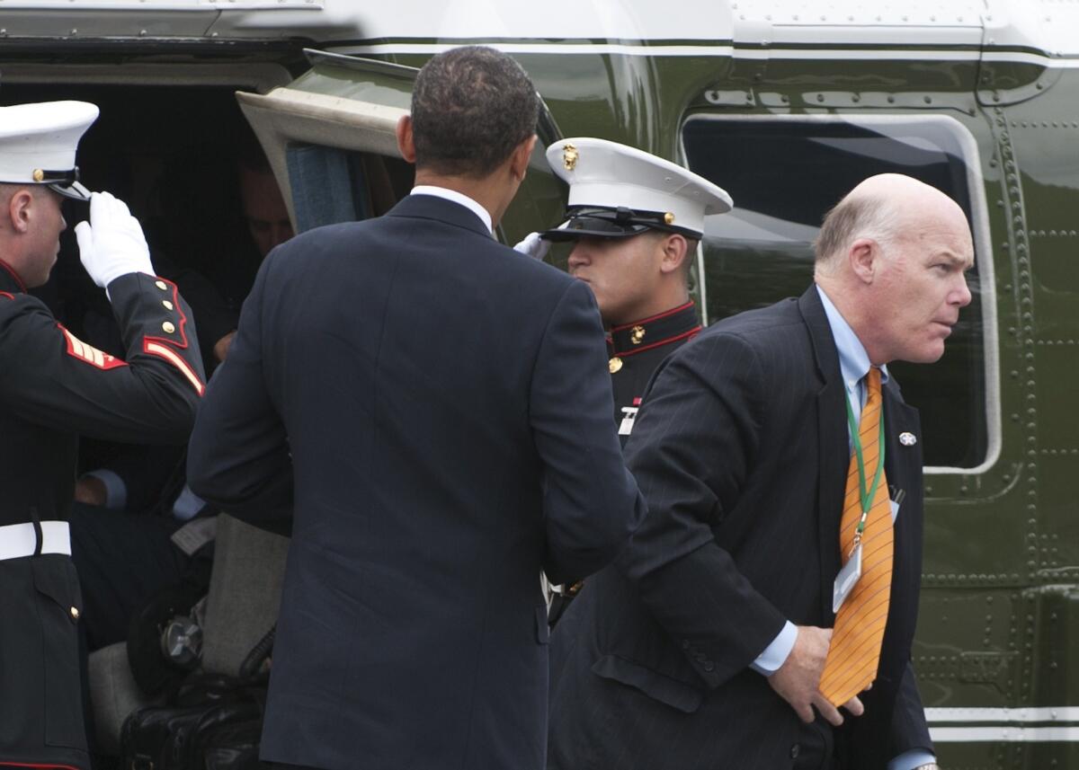 The new acting head of the Secret Service, former agent Joseph Clancy, right, exits a helicopter as part of President Obama's entourage in 2009 in Germany.