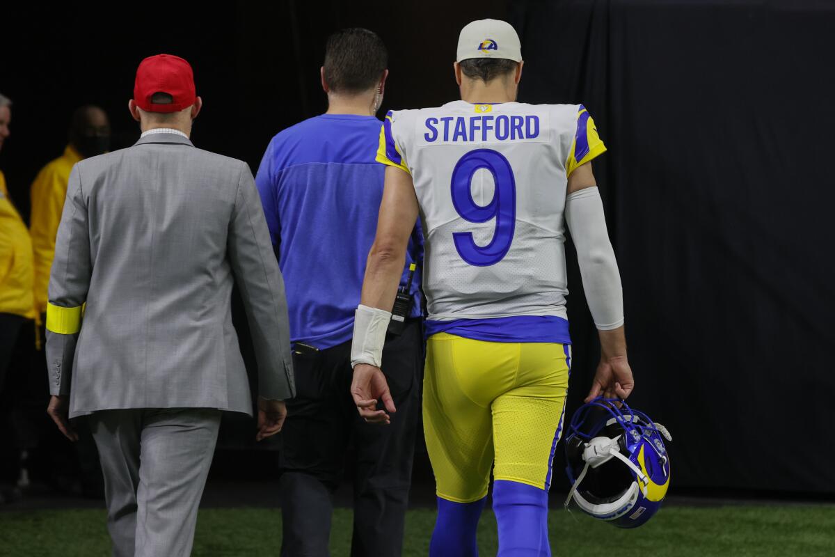 Rams quarterback Matthew Stafford leaves the field against the Saints in 2022 to be examined for a concussion.