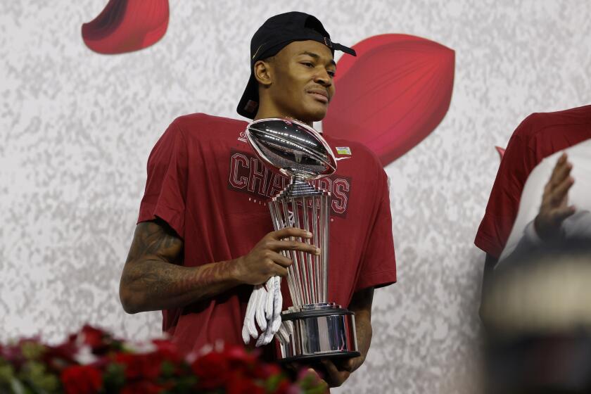 Alabama wide receiver DeVonta Smith holds the trophy after their win against Notre Dame in the Rose Bowl NCAA college football game in Arlington, Texas, Friday, Jan. 1, 2021. (AP Photo/Michael Ainsworth)