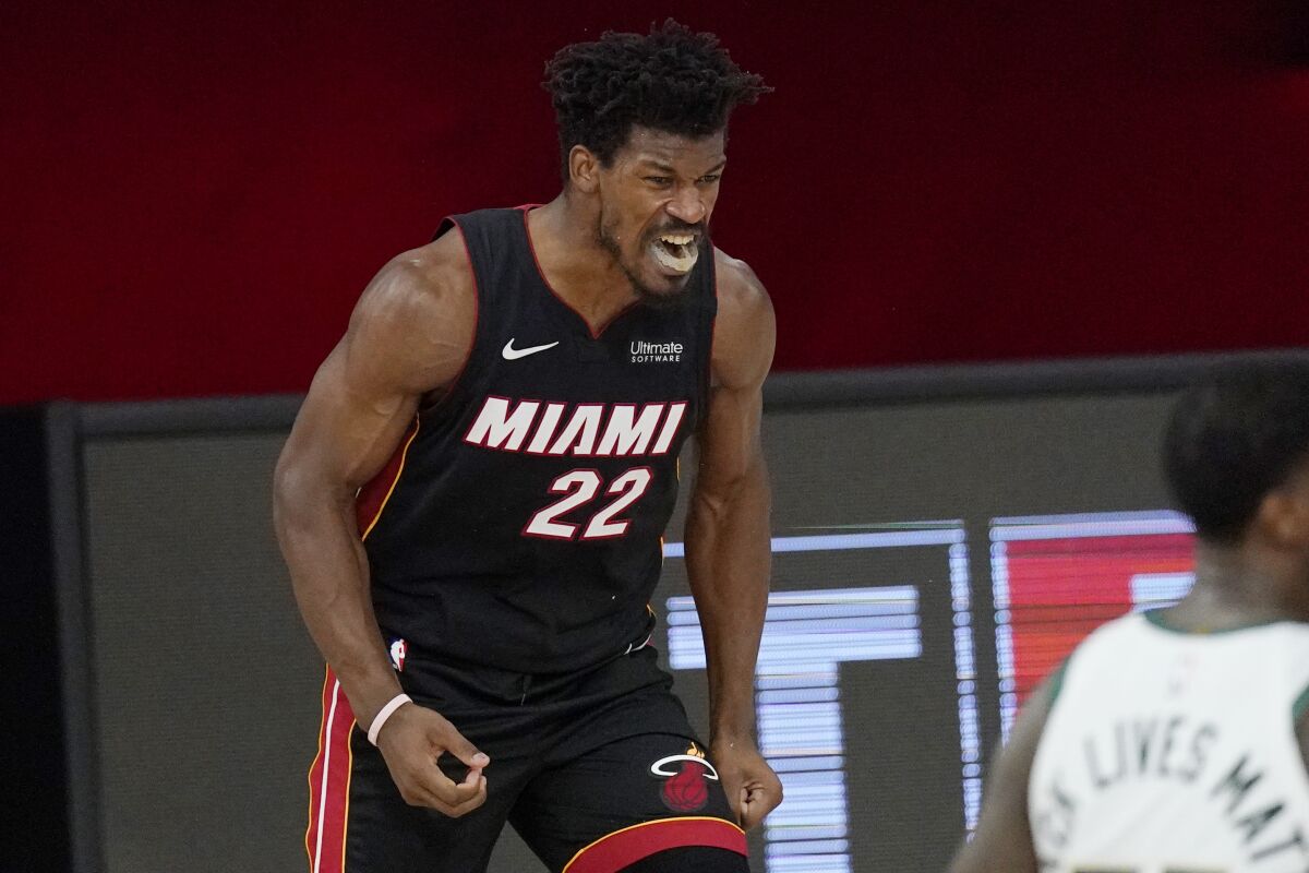 Miami Heat's Jimmy Butler (22) celebrates after a dunk in the second half of an NBA conference semifinal playoff basketball game against the Milwaukee Bucks Friday, Sept. 4, 2020, in Lake Buena Vista, Fla. (AP Photo/Mark J. Terrill)