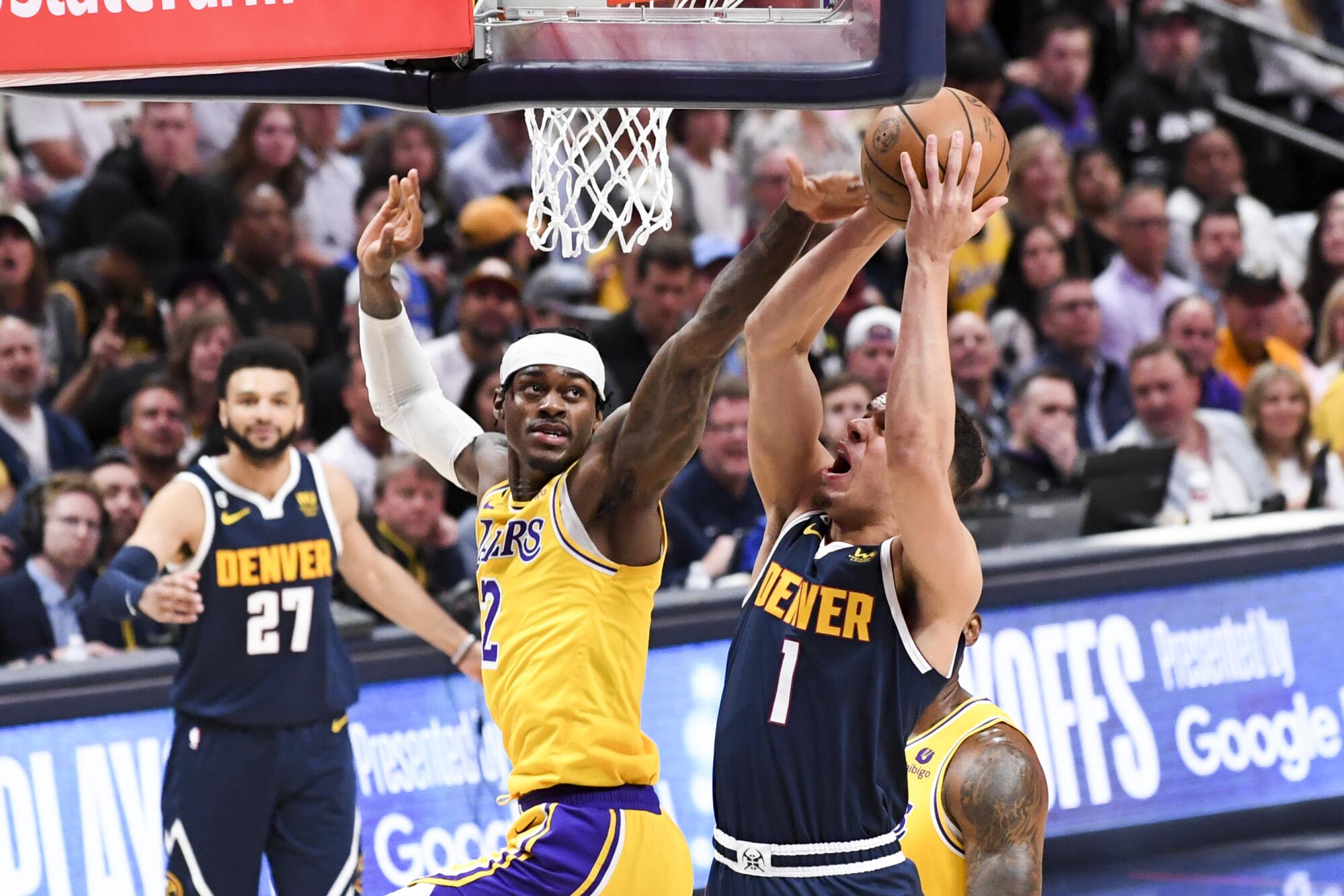 Denver Nuggets forward Michael Porter Jr., right, puts up a shot as Lakers forward Jarred Vanderbilt defends.