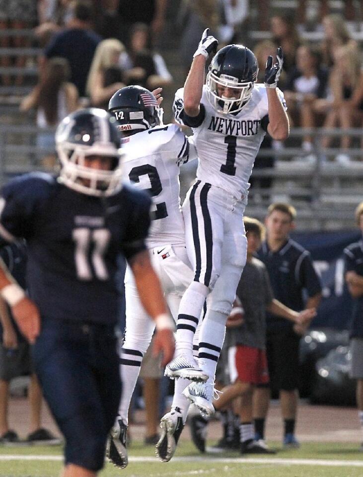Newport Harbor High's Cole Norris, left, and Quest Truxton (1) celebrate a touchdown in the first half of Friday's matchup with Trabuco Hills.