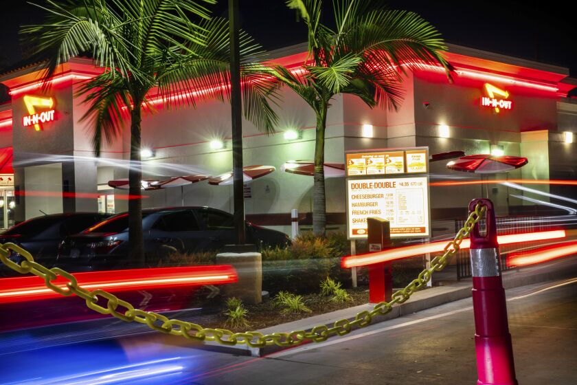 HOLLYWOOD, CA - APRIL 29: The drive-through at In-N-Out Burger in Hollywood, CA, fills the parking lot and out along North Orange Drive, Wednesday, April 29, 2020. While normally a busy drive-through, with the loss of in-store dining, traffic has increased in the popular location according to employees. (Jay L. Clendenin / Los Angeles Times)
