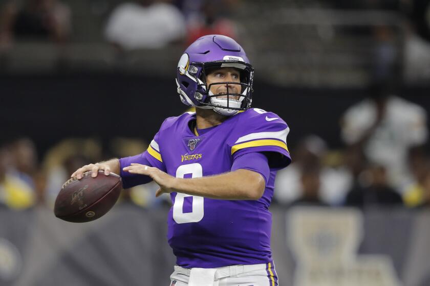 Minnesota Vikings quarterback Kirk Cousins (8) passes in the first half of an NFL preseason football game against the New Orleans Saints in New Orleans, Friday, Aug. 9, 2019. (AP Photo/Bill Feig)
