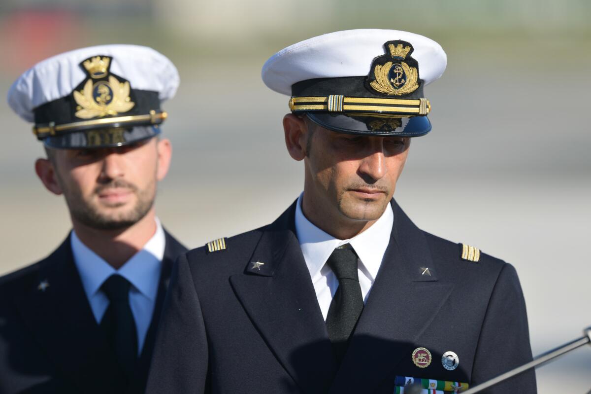 In this photograph taken on December 22, 2012, Italian marines Massimiliano Latorre (R) and Salvatore Girone (L) arrive at Ciampino airport near Rome, on December 22, 2012. India's Supreme Court ruled February 22, 2013 that two Italian marines accused of murdering Indian fishermen while guarding an oil tanker could return home to cast their votes in upcoming national elections. The marines are suspected of shooting dead two fishermen off India's southwestern coast near the port city of Kochi in February 2012, when a fishing boat came close to the Italian oil tanker they were guarding.