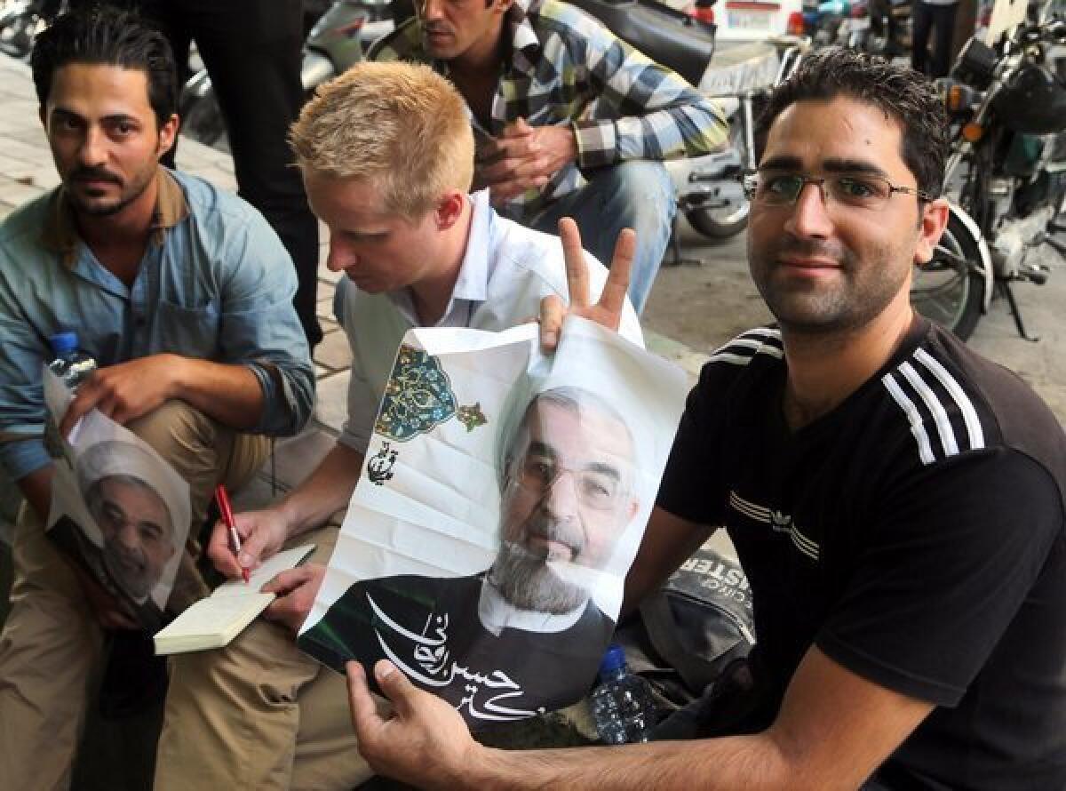 Supporters of Iranian presidential candidate Hassan Rowhani near his campaign office in Tehran, Iran.