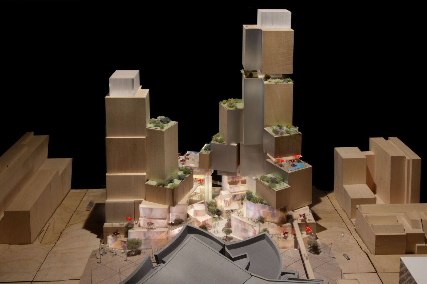 A proposal by architect Frank Gehry's firm calls for a stacked collection of shops and restaurants and includes two towers, one holding an SLS Hotel and the other filled with condominiums and apartments.