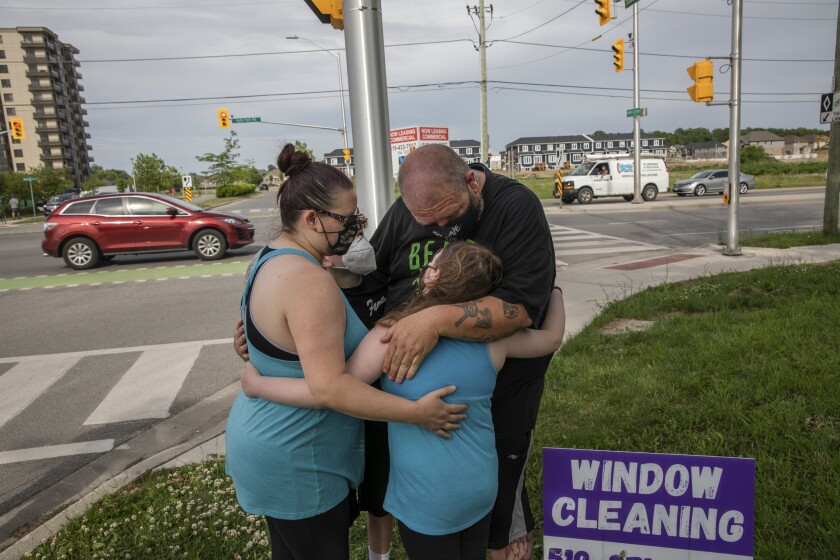 People hug at site of attack on family