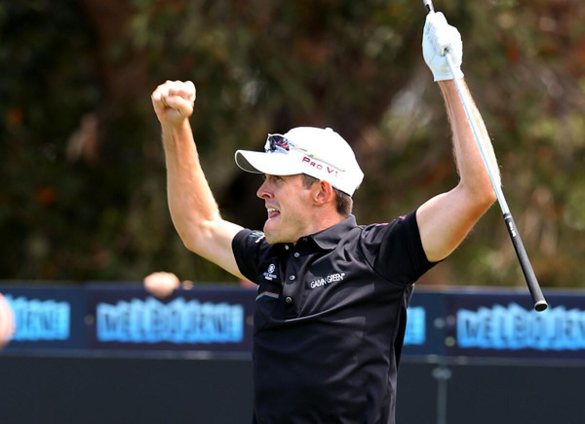 Stuart Manley celebrates after making a hole-in-one at No. 3 on Saturday during the third round of the World Cup of Golf in Melbourne, Australia.