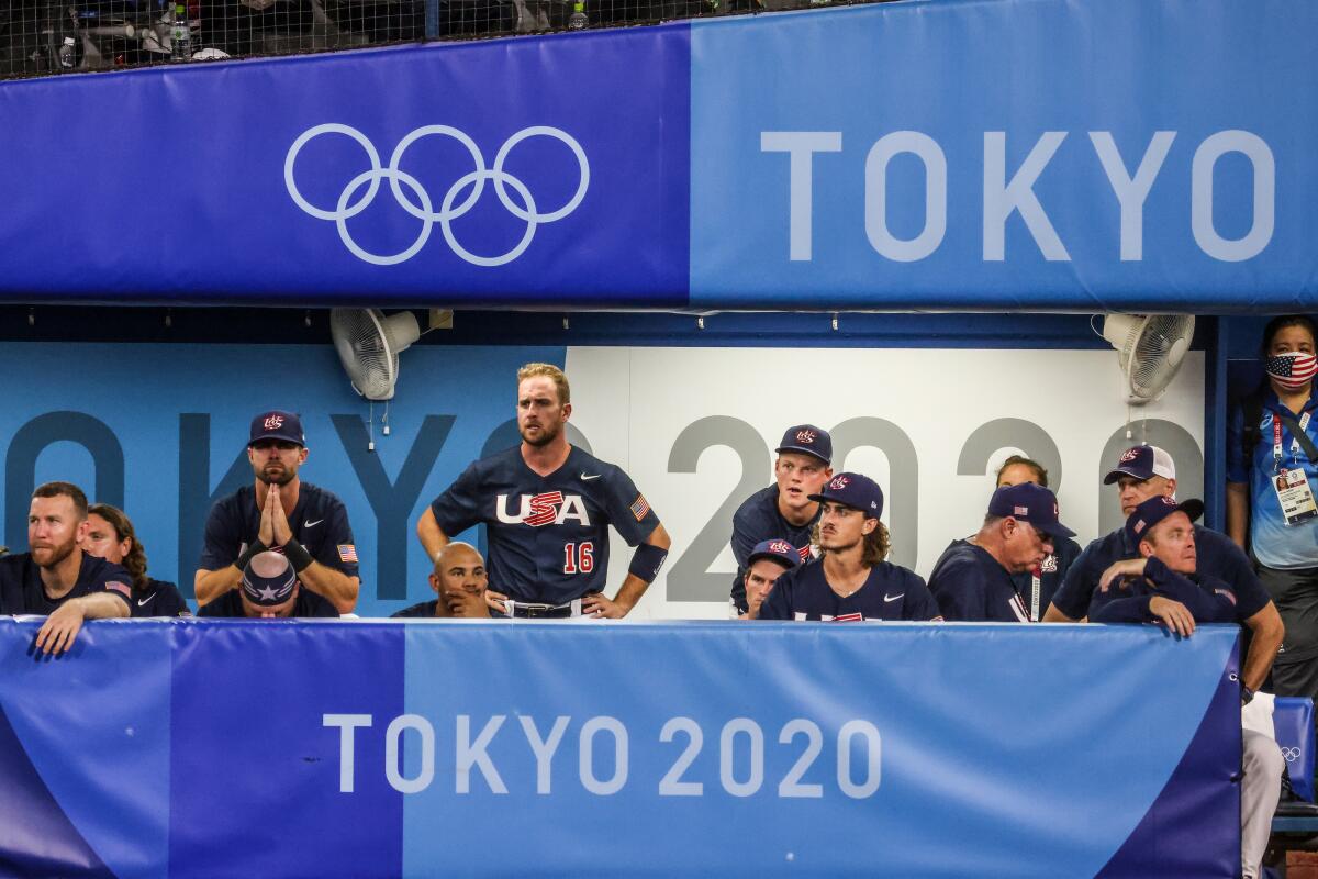 U.S. baseball players watch the field somberly at the Tokyo Olympics.