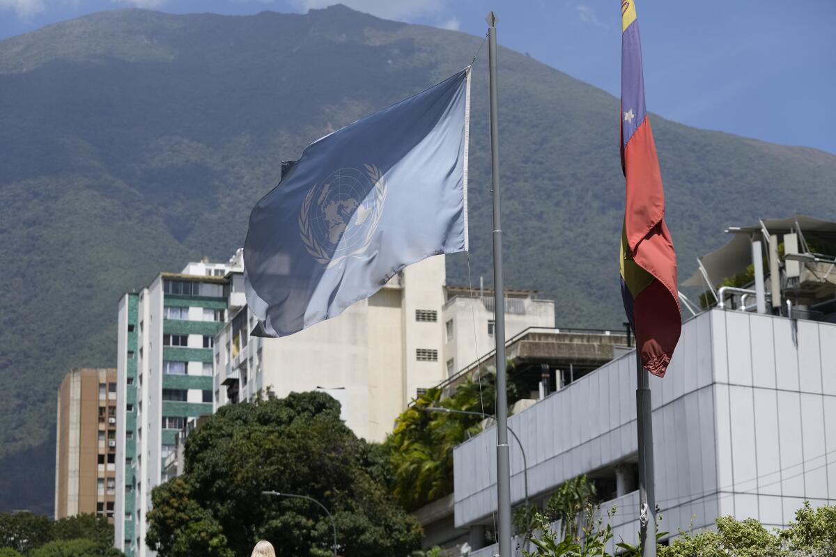 A U.N. and Venezuelan flag hang outside a building in Caracas.