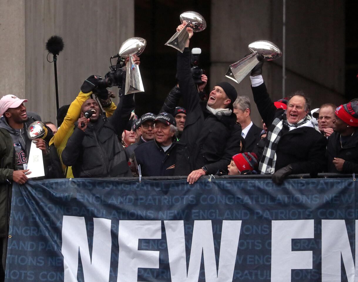 New England Patriots quarterback Tom Brady, head coach Bill Belichick and free safety Devin McCourty, hoist the Lombardi Championship trophies during Super Bowl LI victory parade in Boston, Massachusetts, U.S., February 7, 2017. REUTERS/Barry Chin/Pool ** Usable by SD ONLY **
