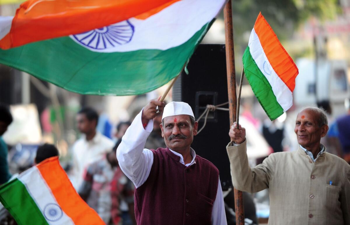 Supporters of Indian activist Anna Hazare celebrate in Allahabad after Parliament passed an anti-corruption measure.