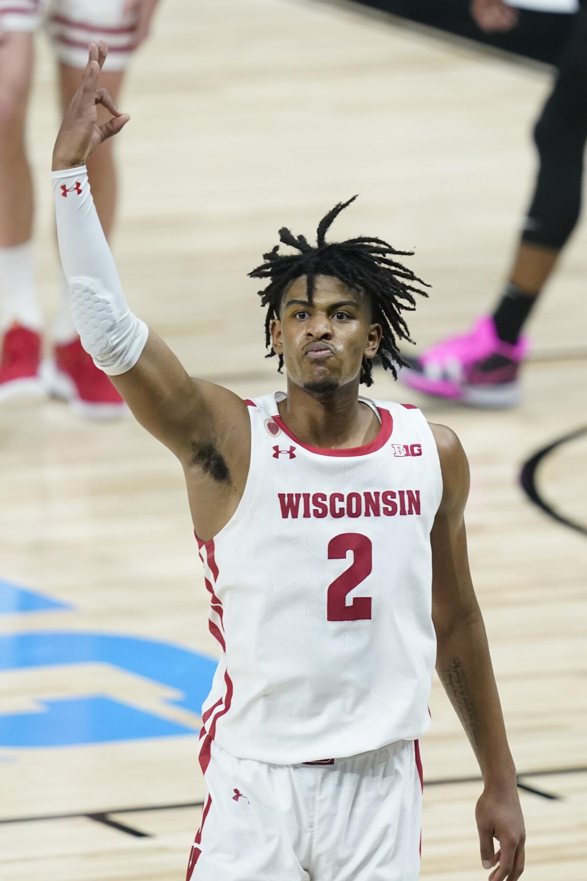 Wisconsin's Aleem Ford reacts after hitting a shot as time expired to end the first half of an NCAA college basketball game against Penn State at the Big Ten Conference tournament, Thursday, March 11, 2021, in Indianapolis. (AP Photo/Darron Cummings)