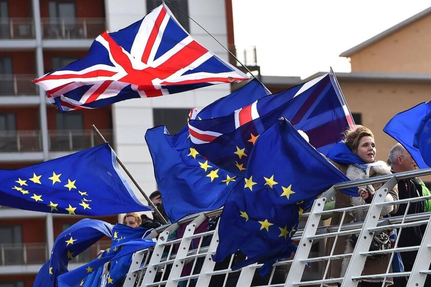 Anti-Brexit activists fly EU and a Union flag from the Millennium Bridge during a demonstration by fishermen on the River Tyne in Newcastle, northeast England on March 15, 2019, against the terms of the current Brexit deal being offered by Britain's Prime Minister Theresa May. - People working in the fishing industry supported by the pro-Brexit Fishing for Leave organisation, launched a flotilla on Friday in protest against the prospect of Britain continuing to adhere to the EU's Common Fisheries Policy that sets quotas and fishing rights during the transition period after Britain has formally left the European Union. (Photo by Andy Buchanan / AFP)ANDY BUCHANAN/AFP/Getty Images ** OUTS - ELSENT, FPG, CM - OUTS * NM, PH, VA if sourced by CT, LA or MoD **