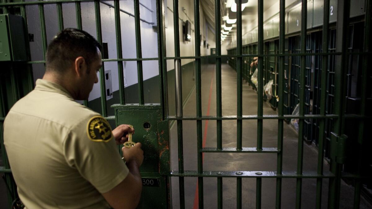 1-A Los Angeles County Sheriff's deputy prepares to unlock a security door at the L.A. County Men's Central Jail.