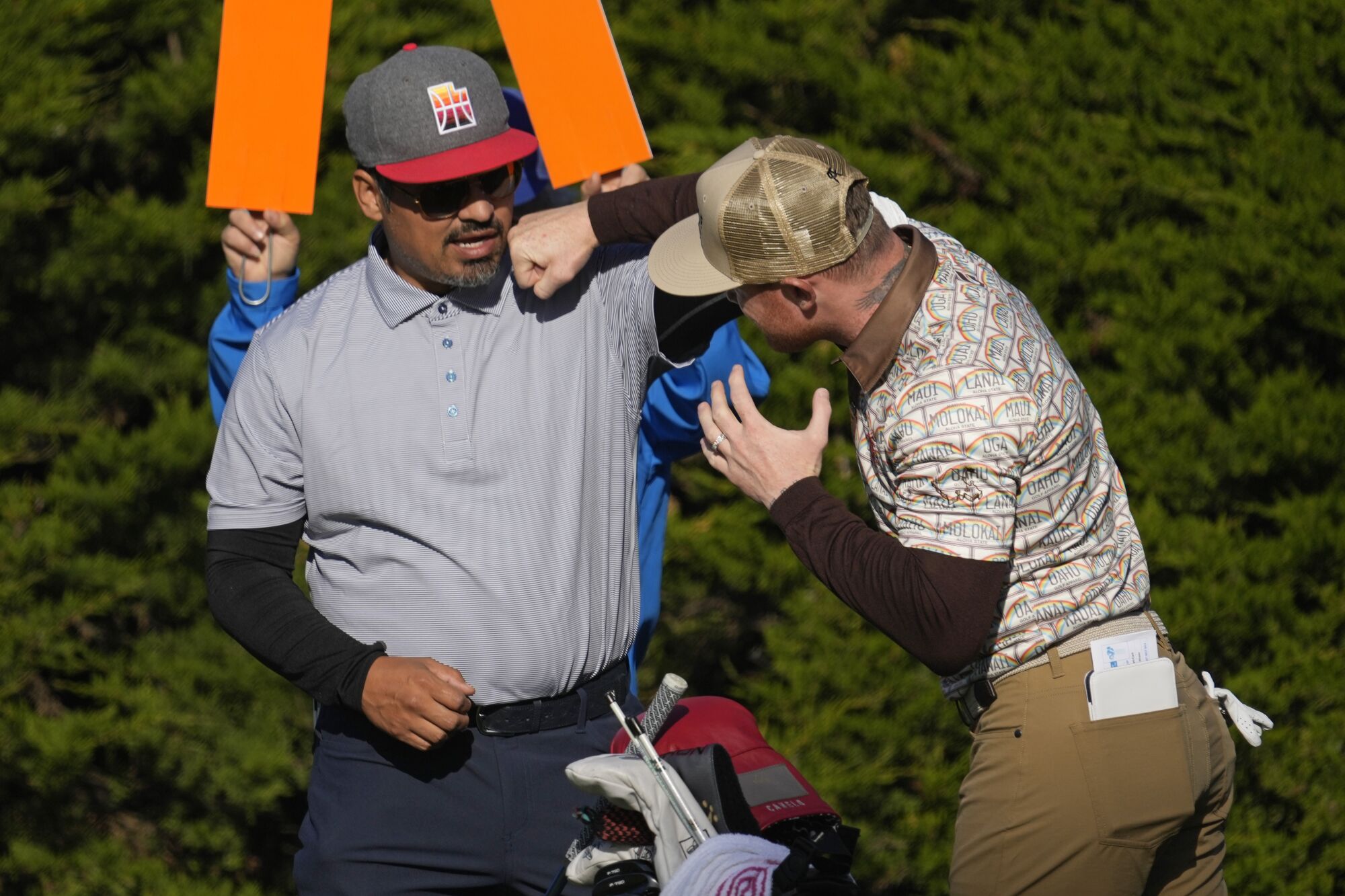 Canelo Alvarez, right, demonstrates a punch to actor Michael Pena during the Pebble Beach Pro-Am in February.