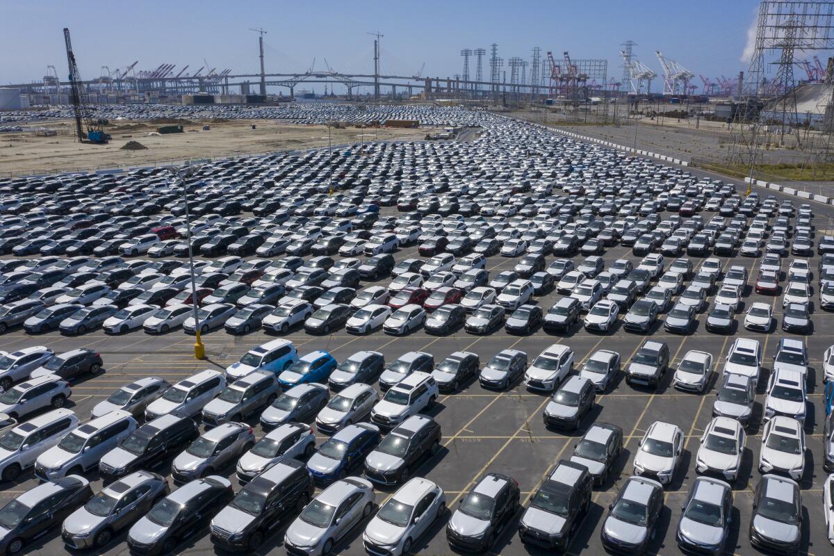 Thousands of new cars are stored in a lot. 
