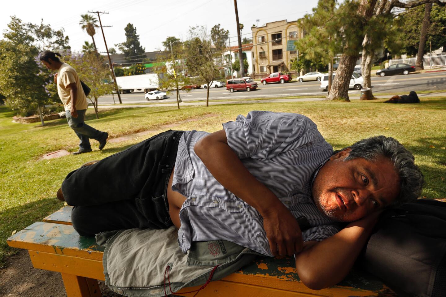 Timoteo Arevalos, 55, rests in Hollenbeck Park in Boyle Heights, June 6. Arevalos, who has been homeless for a few months, spends his days in the park. "I feel safe. This is home," he said.