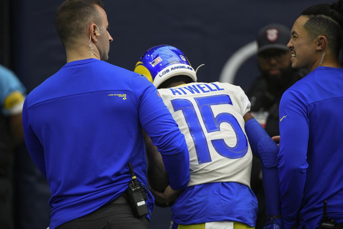 Rams wide receiver Tutu Atwell (15) is escorted off the field after getting injured in an October road game against Houston.