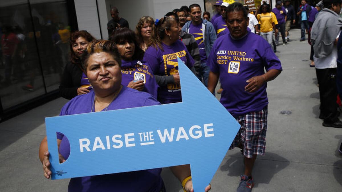 SEIU workers march in downtown Los Angeles earlier this year for a higher minimum wage.