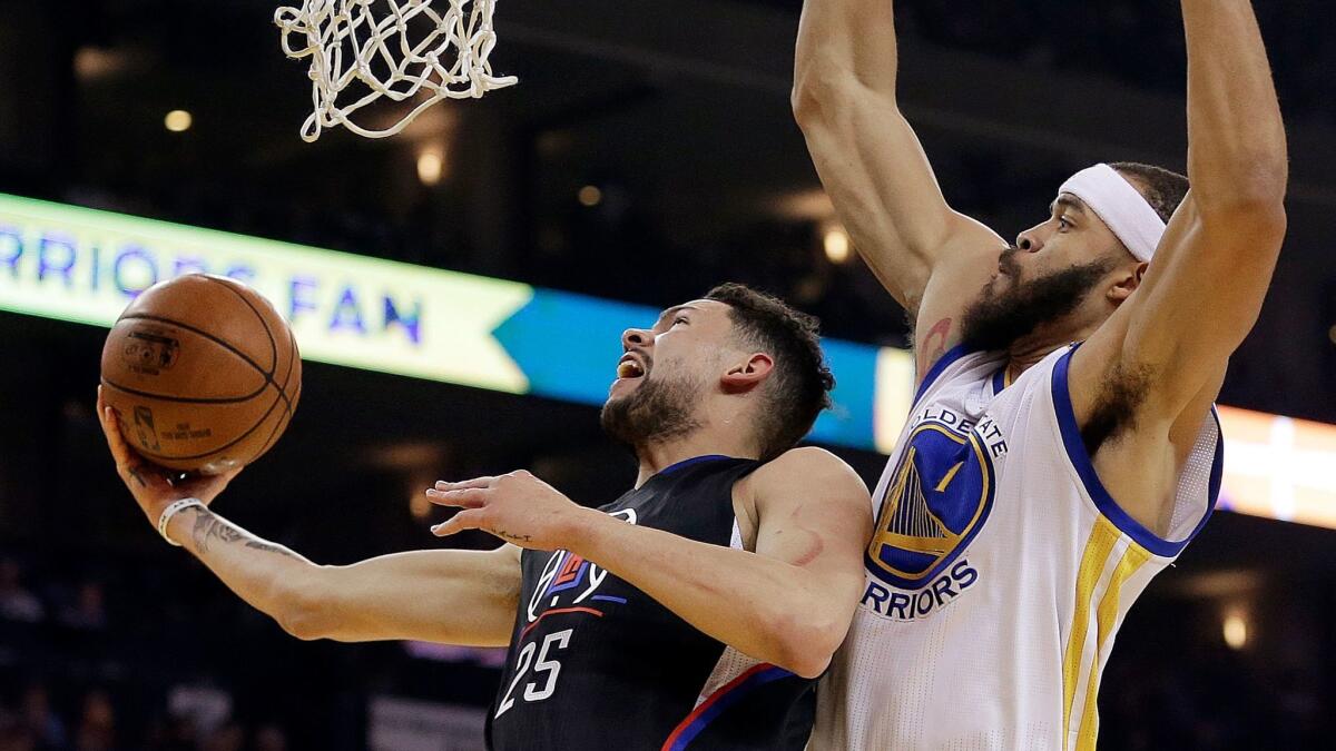 Austin Rivers, left, drives against Golden State's JaVale McGee on Feb. 23.