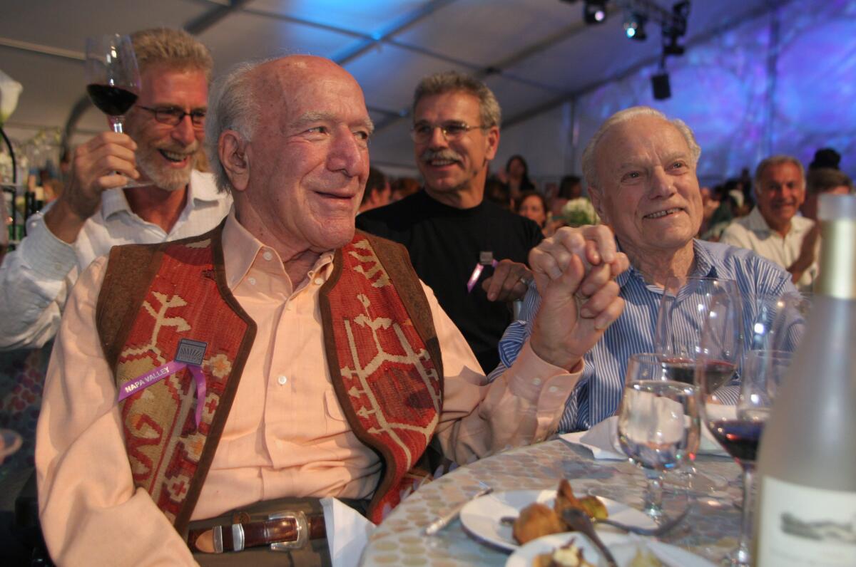 Wine makers Peter Mondavi, right, and his brother Robert Mondavi hold hands at the 26th annual Auction Napa Valley at Meadowwood Resort on June 3, 2006, in St. Helena, Calif. Peter Mondavi died at the age of 101 on Feb. 20.