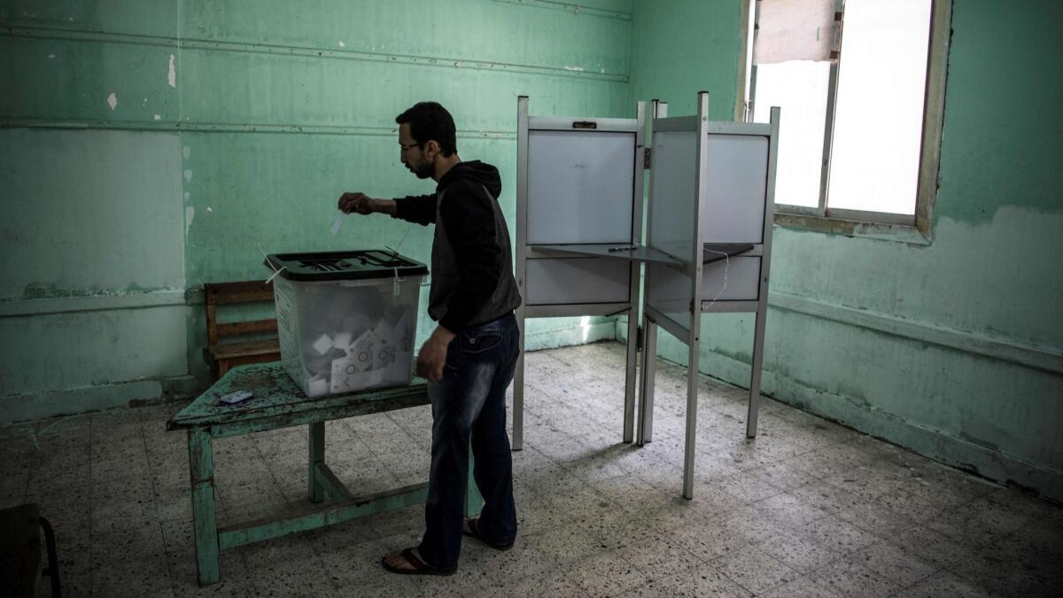 An Egyptian man casts his vote in Cairo on Monday, the third day of a constitutional referendum.