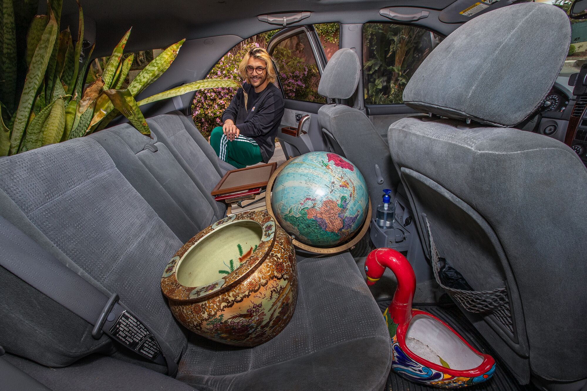 Max Bennett Kelly, 26, of Hollywood, loads the back seat of his car with items he purchased.