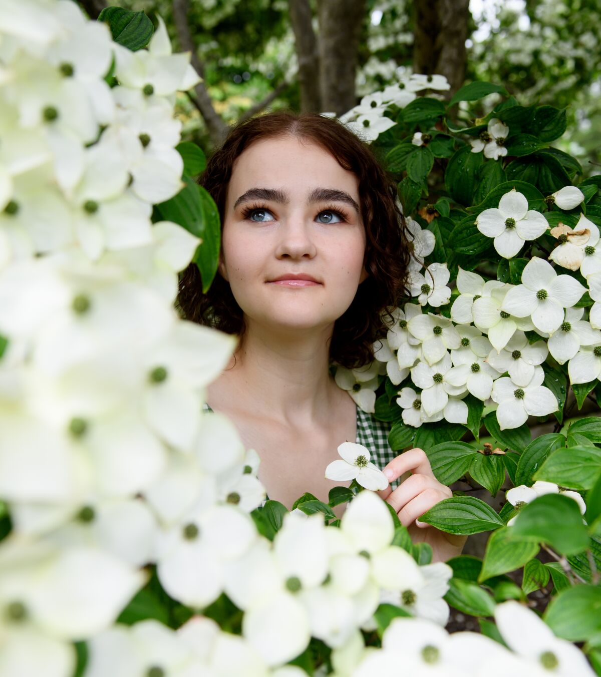 Millicent Simmonds amid boughs of flowers at the Phipps Conservatory in Pittsburgh.