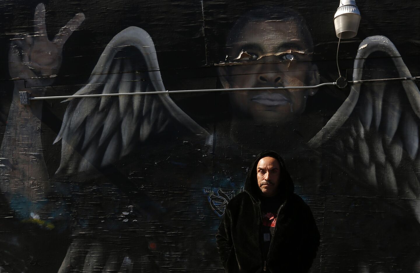 Ricardo Guerrero, social/art director at The Graff Lab, stands in front of a mural created in memory of Juan Carlos De La Piedra in the Pico Union area of the Westlake neighborhood. De La Piedra was fatally shot in 2012 in a walk-up shooting that police believe was gang-related.