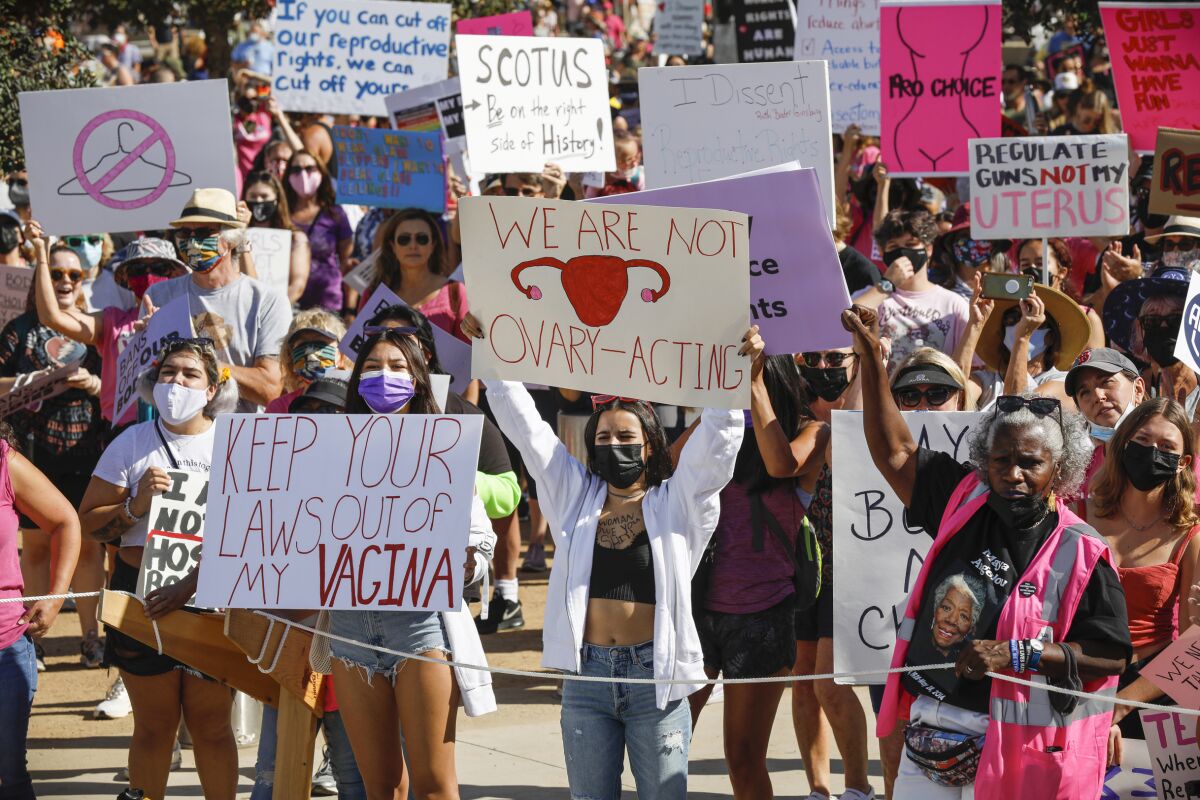 A crowd holds signs during a reproductive rights rally 