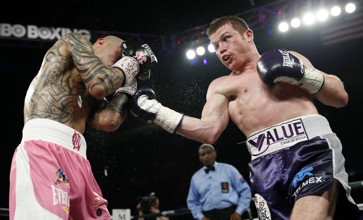 Saul "Canelo" Alvarez, right, attempts an uppercut on Miguel Cotto during their WBC middleweight title bout on Nov. 21 in Las Vegas.