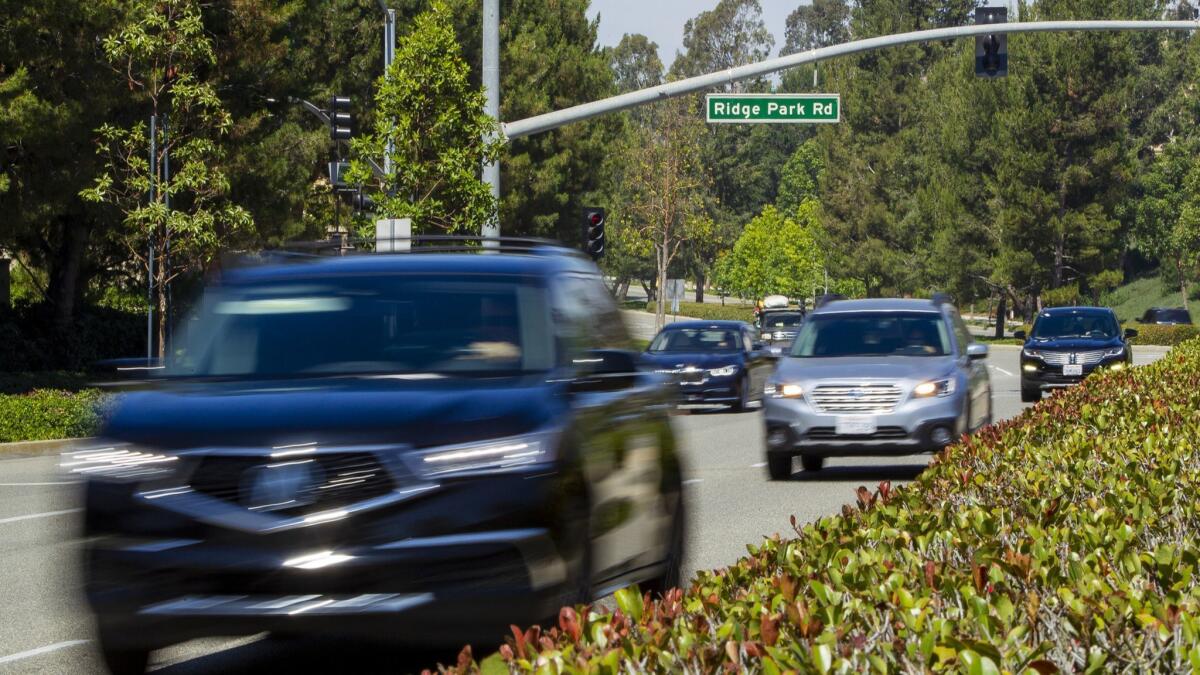 Cars travel on San Joaquin Hills Road between Ridge Park Road and Newport Coast Drive in Newport Coast on Thursday.