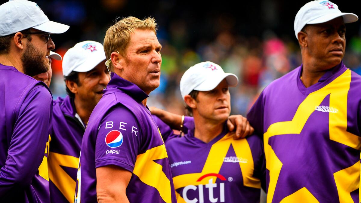 Shane Warne (no hat) gathers with his teammates before their Cricket All-Stars series opener at Citi Field last Saturday.