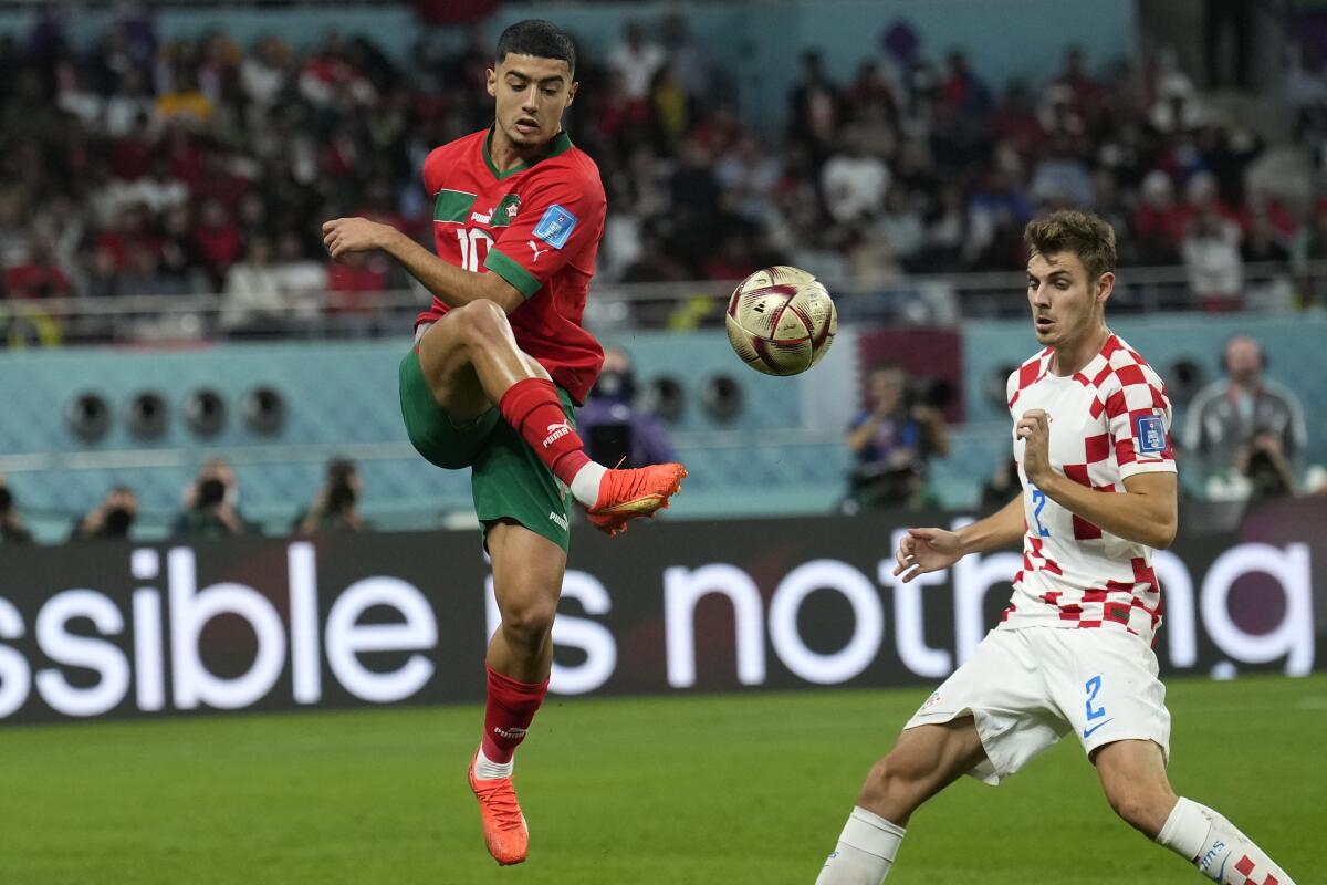 Morocco's Anass Zaroury, left, kicks the ball past Croatia's Josip Stanisic during the third-place game Saturday.